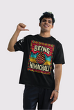 Black T-shirt featuring white text 'Being Himachali' with a detailed pine cone graphic, perfect for Himachal Pradesh lovers and nature enthusiasts."