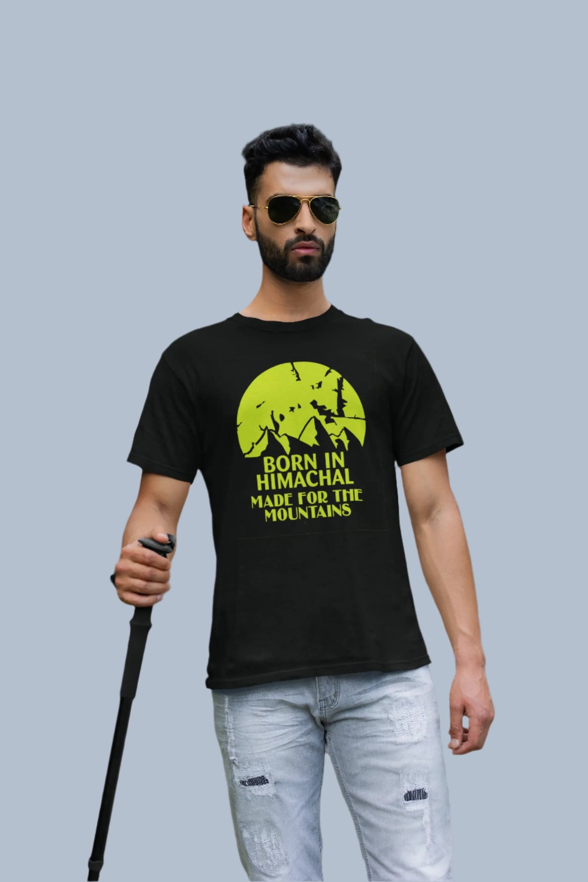 "Black T-shirt featuring bold GREEN text 'BORN IN THE HIMACHAL,' ideal for proud Himachalis and mountain enthusiasts."