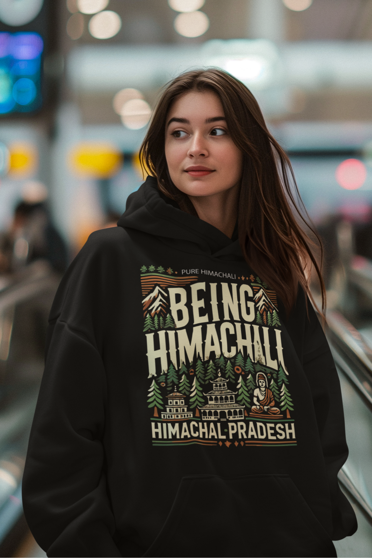 "Black hoodie featuring a bold Himachali-themed illustration with the text 'Being Himachali,' crafted from soft cotton-polyester fabric for a unisex fit."