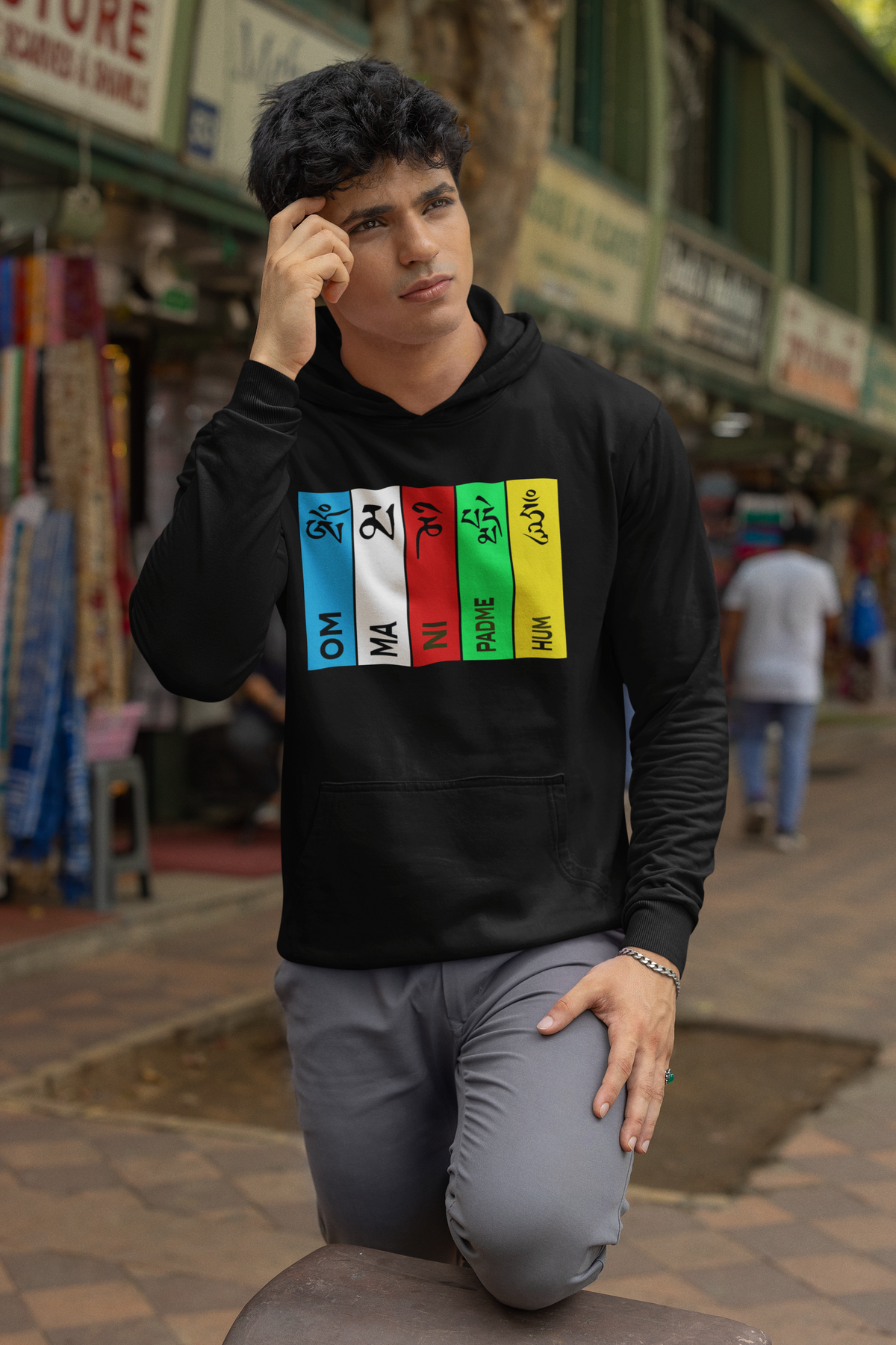 "Black hoodie featuring an intricate design of the Buddhist mantra 'Om Mani Padme Hum,' crafted from a soft cotton-polyester blend with a unisex fit."