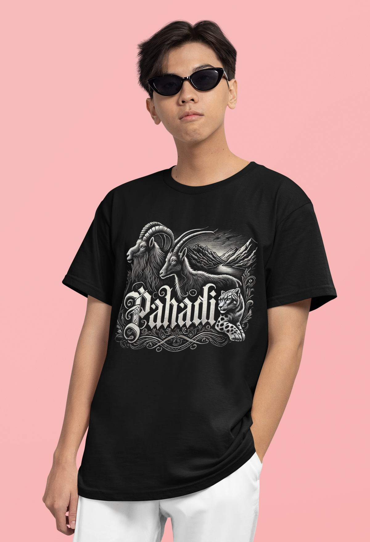 "Black t-shirt with the word 'Pahadi' in bold, gothic-style typography, featuring sharp white and red accents. The striking design blends modern aesthetics with mountain pride, set against a classic black background."